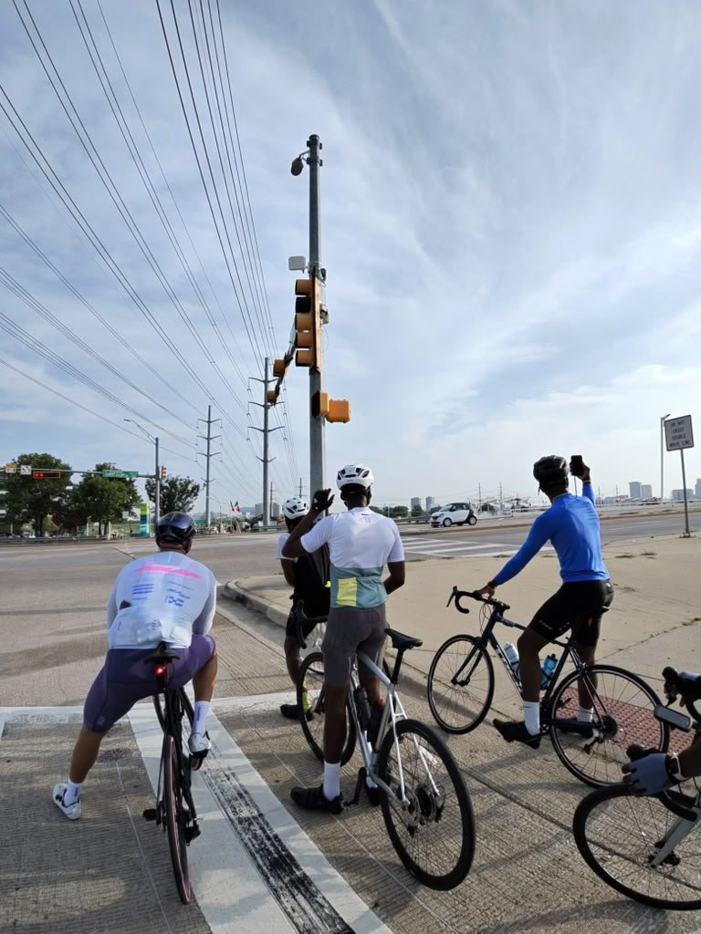 Riders waiting at a light with the skyline behind