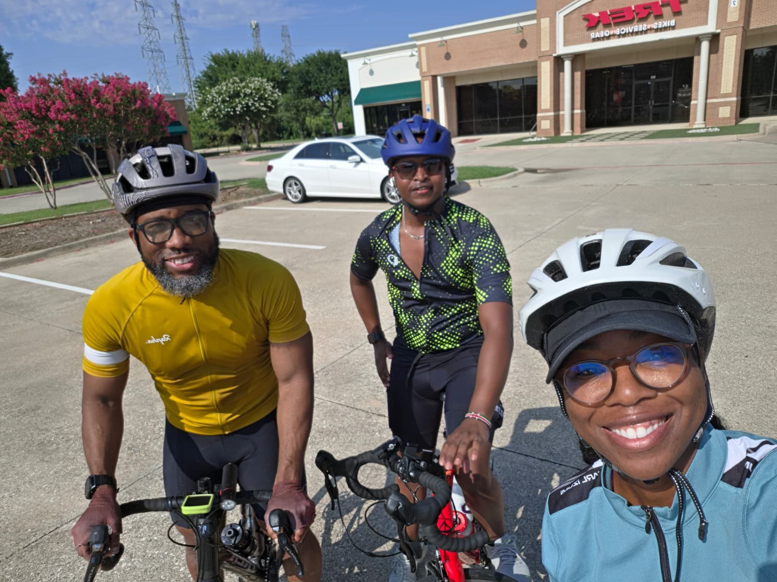Three riders outside the bike shop